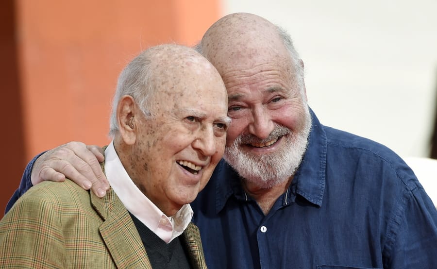 Carl Reiner, left, and his son Rob Reiner pose together April 7, 2017, following their hand and footprint ceremony at the TCL Chinese Theatre in Los Angeles. Carl Reiner died of natural causes on Monday night at his home in Beverly Hills, Calif. He was 98.