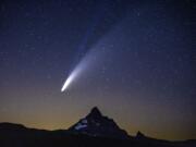 Comet Neowise appears over Mount Washington in the night sky as seen from Dee Wright Observatory on McKenzie Pass east of Springfield, Ore., last week. According to NASA, the lower tail, which appears broad and fuzzy, is the dust tail created when dust lifts off the surface of the comet&#039;s nucleus and trails behind the comet in its orbit. The upper tail is the ion tail, which is made up of gases that have been ionized by losing electrons in the sun&#039;s intense light.