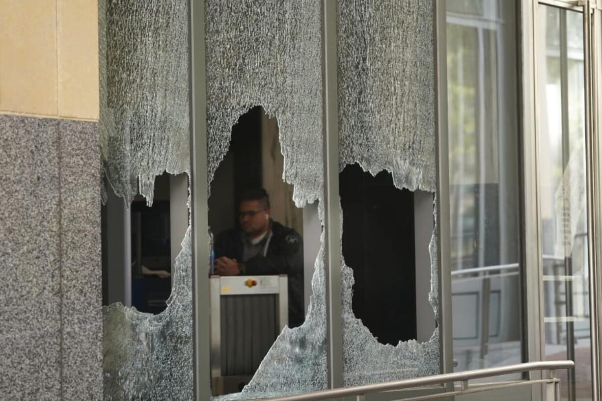 A protester holds a homemade riot shield during a protest in front of the Oakland Police Department Station on Saturday, July 25, 2020, in Oakland, Calif. Protesters in California set fire to a courthouse, damaged a police station and assaulted officers after a peaceful demonstration intensified late Saturday, Oakland police said.