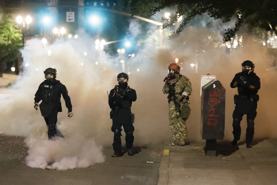 Federal officers advance of demonstrators during a Black Lives Matter protest at the Mark O. Hatfield United States Courthouse Monday, July 27, 2020, in Portland, Ore.