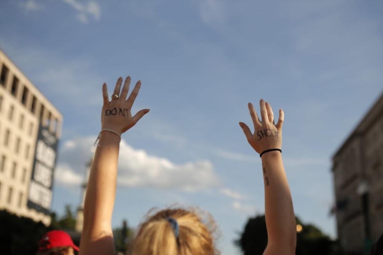 FILE - In this June 24, 2020, file photo protesters gather near the White House in Washington amid continuing anti-racism demonstrations following the death of George Floyd, a Black man who was restrained by police in Minneapolis. A majority of white Democrats today say police officers are more likely to use deadly force against a Black person than a white person, according to a recent poll from The Associated Press-NORC Center for Public Affairs Research, not unlike five years ago.