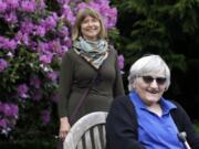 Jessie Cornwell, a resident of the Ida Culver House Ravenna, right, poses for a photo with the Rev. Jane Pauw, in Seattle on May 21, 2020. Cornwell tested positive for the coronavirus but never became ill, and may have been infectious when she shared a ride to Bible study with Pauw, who later got sick with COVID-19.