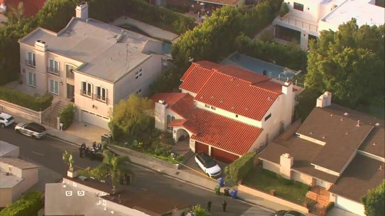 This aerial photo taken from video provided by Fox11 News KTTV-TV shows the Hollywood Hills home, center, where Pop Smoke, 20, was shot and killed early Feb. 19, 2020, in Los Angeles. Authorities say three men and two juveniles have been arrested in connection with the home-invasion death of the rising rapper.