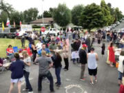 A screen shot from a Facebook Live video on People's Rights Washington's page shows a gathering of protesters outside Vancouver City Prosecutor Kevin McClure's home on Sunday.