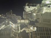 In this image taken from NASA video, commander Chris Cassidy, right, and NASA astronaut Bob Behnken perform their second spacewalk in under a week Wednesday, July 1, 2020, to replace old batteries outside the International Space Station.