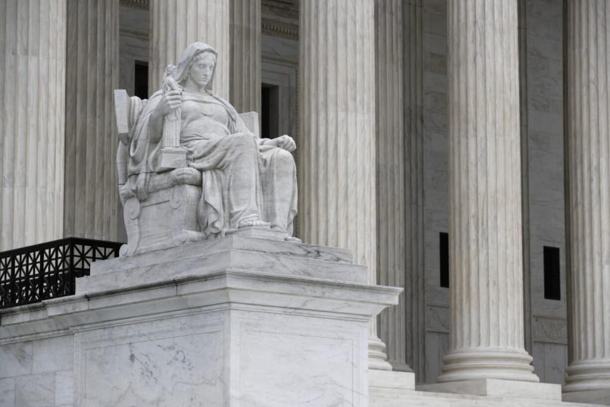 The Contemplation of Justice statue stands outside the Supreme Court on Capitol Hill in Washington, Monday, July 6, 2020.