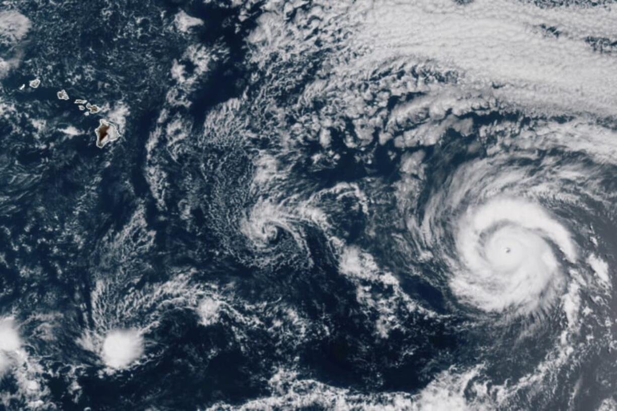 This GOES-17 taken at 3:30 p.m. EDT, Thursday, July 23, 2020, shows Hurricane Douglas, right, churning in the Pacific Ocean heading towards Hawaii, left. The storm is currently a Category 3 hurricane but is expected to weaken before it arrives in the state this weekend.