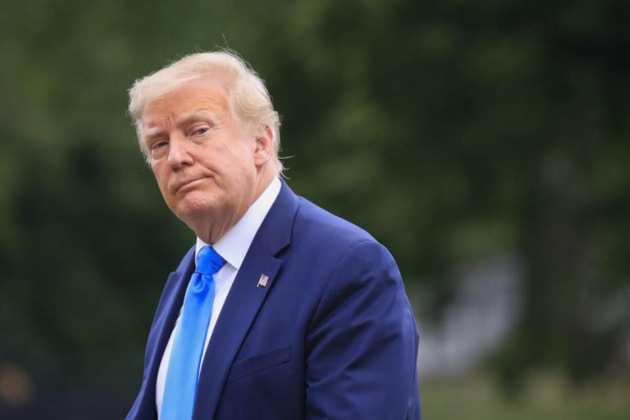 President Donald Trump walks across the South Lawn of the White House in Washington, Saturday, July 11, 2020. Trump was returning from a visit to nearby Walter Reed National Military Medical Center in Bethesda, Md.