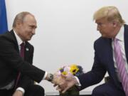 FILE - In this June 28, 2019, file photo President Donald Trump, right, shakes hands with Russian President Vladimir Putin, left, during a bilateral meeting on the sidelines of the G-20 summit in Osaka, Japan. For the past three years, the administration has careered between President Donald Trump&#039;s attempts to curry favor and friendship with Vladimir Putin and longstanding deep-seated concerns about Putin&#039;s intentions.