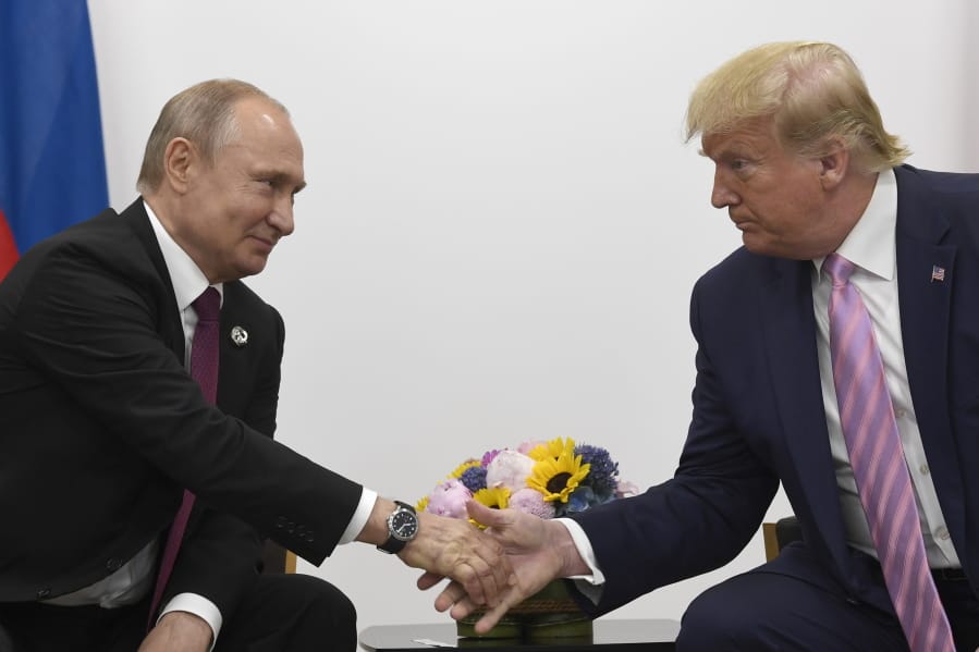 FILE - In this June 28, 2019, file photo President Donald Trump, right, shakes hands with Russian President Vladimir Putin, left, during a bilateral meeting on the sidelines of the G-20 summit in Osaka, Japan. For the past three years, the administration has careered between President Donald Trump&#039;s attempts to curry favor and friendship with Vladimir Putin and longstanding deep-seated concerns about Putin&#039;s intentions.