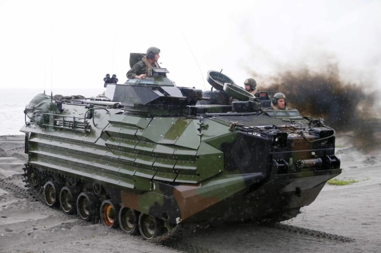 FILE - U.S. Marines from the 3rd Marine Expeditionary Brigade ride on their Amphibious Assault Vehicle (AAV) during the joint US-Philippines amphibious landing exercise Friday Oct.7, 2016 at Naval Education Training Command in San Antonio northwest of Manila, Philippines. A training accident off the coast of Southern California in an AAV similar to this one has taken the life of one Marine, injured two others and left eight missing Thursday, July 30, 2020. In a Friday morning tweet, the Marines say the accident happened Thursday and search and rescue efforts are underway with support from the Navy and Coast Guard.