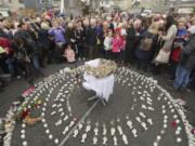 FILE - In this Aug. 26, 2018 file photo, People gather to protest at the site of the former Tuam home for unmarried mothers in County Galway, Ireland. The Vatican has indicated its support for a campaign to exhume the bodies of hundreds of babies who were buried on the grounds of a Catholic-run Irish home for unwed mothers to give them a proper Christian burial. The Vatican&#039;s ambassador to Ireland, Archbishop Jude Thaddeus Okolo, said in a July 15, 2020 letter to the amateur Irish historian behind the campaign that he shared the views of the archbishop of Tuam, Ireland, Michael Neary, who has said it was a &quot;priority&quot; for him to re-inter the bodies in consecrated ground.