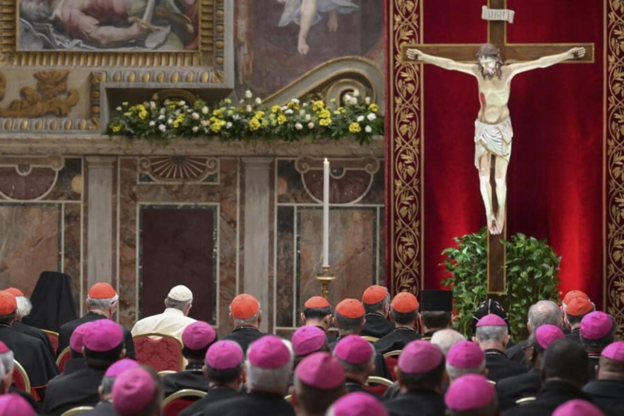 FILE - In this Saturday, Feb. 23, 2019 file photo, Pope Francis, background third from left, attends a penitential liturgy in the wake of his extraordinary summit of Catholic leaders summoned to Rome for a tutorial on preventing clergy sexual abuse and protecting children from predator priests. The Vatican told bishops around the world on Thursday, July 16, 2020 they should report case of clergy sex crimes to police even when not legally bound to do so, in its latest effort to compel church leaders to protect minors from predator priests. The Vatican issued a long-awaited manual for bishops and religious superiors on conducting in-house investigations into allegations of priests who rape and molest minors and vulnerable adults.