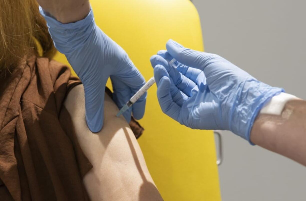 In this handout photo released by the University of Oxford a volunteer participates in the vaccine trial in Oxford, England on July 7, 2020. Scientists at Oxford University say their experimental coronavirus vaccine has been shown in an early trial to prompt a protective immune response in hundreds of people who got the shot. In research published Monday July 20, 2020 in the journal Lancet, scientists said that they found their experimental COVID-19 vaccine produced a dual immune response in people aged 18 to 55.