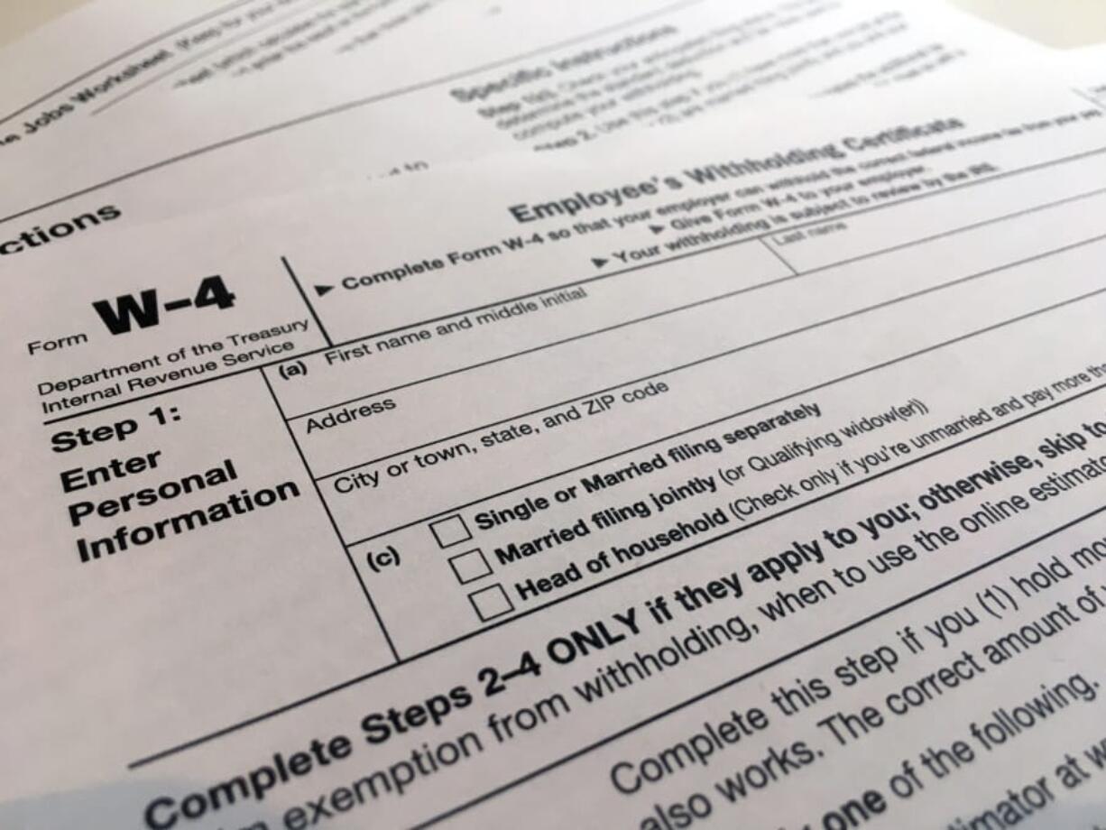 FILE - In this Feb. 5, 2020, file photo, a W-4 form is viewed in New York. As the coronavirus pandemic took hold this spring, the federal government postponed the traditional April 15 filing deadline until July 15. The move provided some economic and logistic relief for taxpayers dealing with the disruptions and uncertainty brought on by lockdowns, school closures and shuttered businesses. But now that new deadline is rapidly approaching.