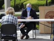 Washington state Gov. Jay Inslee listens at an outdoor round table meeting with leaders in local government, health care and business talking about the high rate of coronavirus cases in the area at Yakima Valley College Tuesday, June 16, 2020, in Yakima, Wash. Inslee met to discuss the impact of the COVID-19 pandemic in the area, which has one of the highest rates of infection in the state.