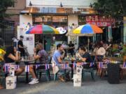 Diners eat al fresco due to COVID-19 concerns in the West Village, Friday, June 26, 2020, in New York. New York City Mayor Bill de Blasio says he&#039;s delaying the planned resumption of indoor dining at restaurants in the city out of fear it would ignite a spike in coronavirus infections.