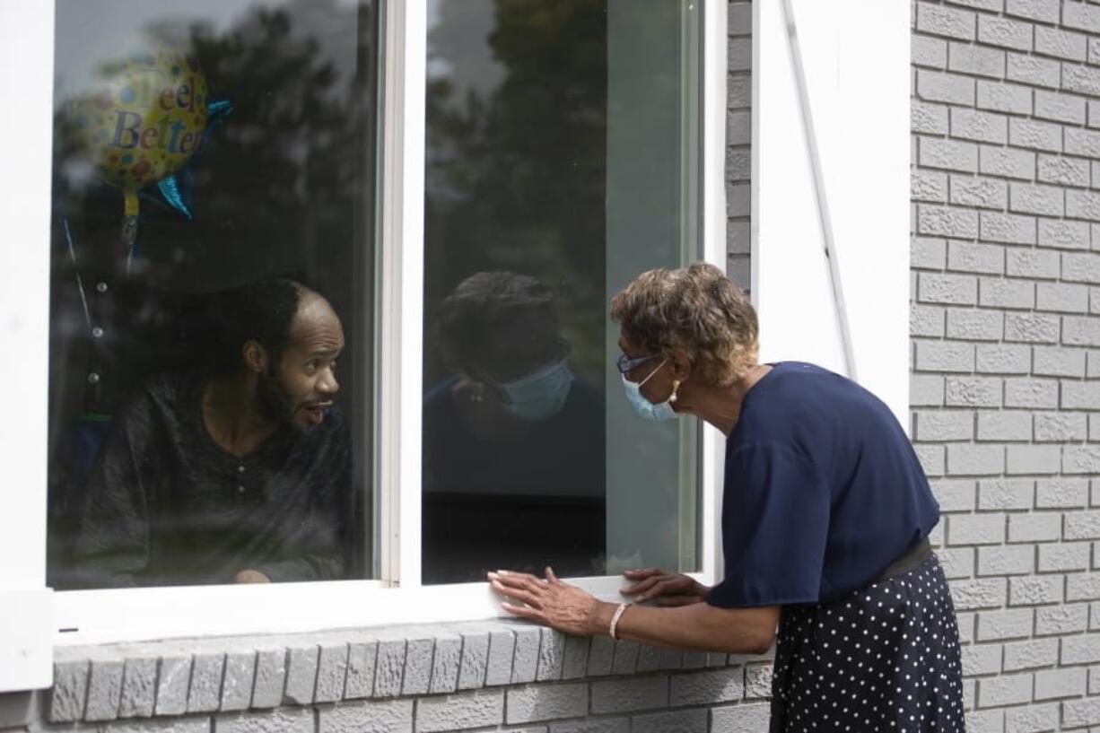 Southern Pines nursing home resident Wayne Swint gets a birthday visit from his mother, Clemittee Swint, in Warner Robins, Ga., on Friday, June 26, 2020. Face to face visits are not allowed but staff members help arrange window visits.