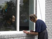 Southern Pines nursing home resident Wayne Swint gets a birthday visit from his mother, Clemittee Swint, in Warner Robins, Ga., on Friday, June 26, 2020. Face to face visits are not allowed but staff members help arrange window visits.