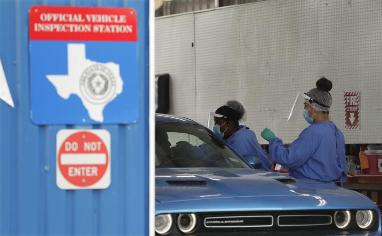 COVID-19 antibody testing and diagnostic testing are administered at a converted vehicle inspection station, Tuesday, July 7, 2020, in San Antonio. Local officials across Texas say their hospitals are becoming increasingly stretched and are in danger of becoming overrun as cases of the coronavirus surge.