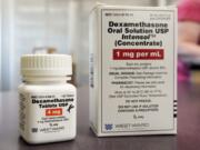 FILE - This Tuesday, June 16, 2020 file photo shows a bottle and box for dexamethasone in a pharmacy in Omaha, Neb. On Friday, July 17, 2020, British researchers published a report on the only drug shown to improve survival -- the inexpensive steroid dexamethasone. Two other studies found that the malaria drug hydroxychloroquine does not help people with only mild coronavirus symptoms.