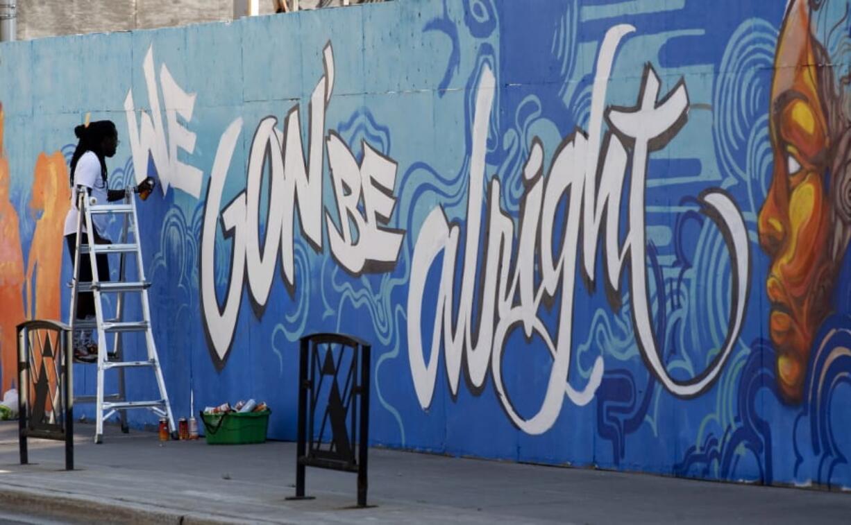 FILE - In this July 10, 2020, file photo, Artist Jimmy Baptiste works on a mural in Ottawa. 2020 is barely halfway over. That hasn&#039;t stopped many people from declaring the year canceled and wishing it would end.