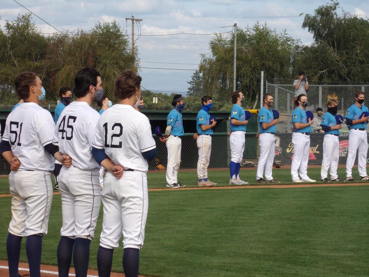 Players line up during the national anthem at the Wild Wild West League opener Saturday, July 11, 2020 at North Marion High School in Aurora, Ore.