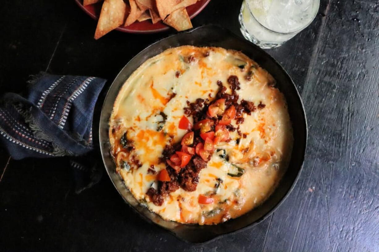 Queso fundido with chorizo and roasted poblano peppers is a satisfying, cheesy appetizer.