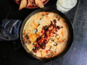 Queso fundido with chorizo and roasted poblano peppers is a satisfying, cheesy appetizer.