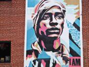 This installation by Shepard Fairey was created as part of the campaign called &quot;Walls for Black Lives&quot; and will hang in eight cities nationwide, including Raleigh, where it was hung by locals at The Cortez off of Glenwood Avenue on July 20.