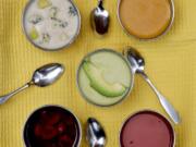 Summer soups, clockwise from top left: Chilled Stilton and Pear Soup, Cold Carrot-Coconut Soup, Lightly Spiced Tomato Soup, Cherry Soup, and center, Curried Avocado Soup. (Hillary Levin/St.