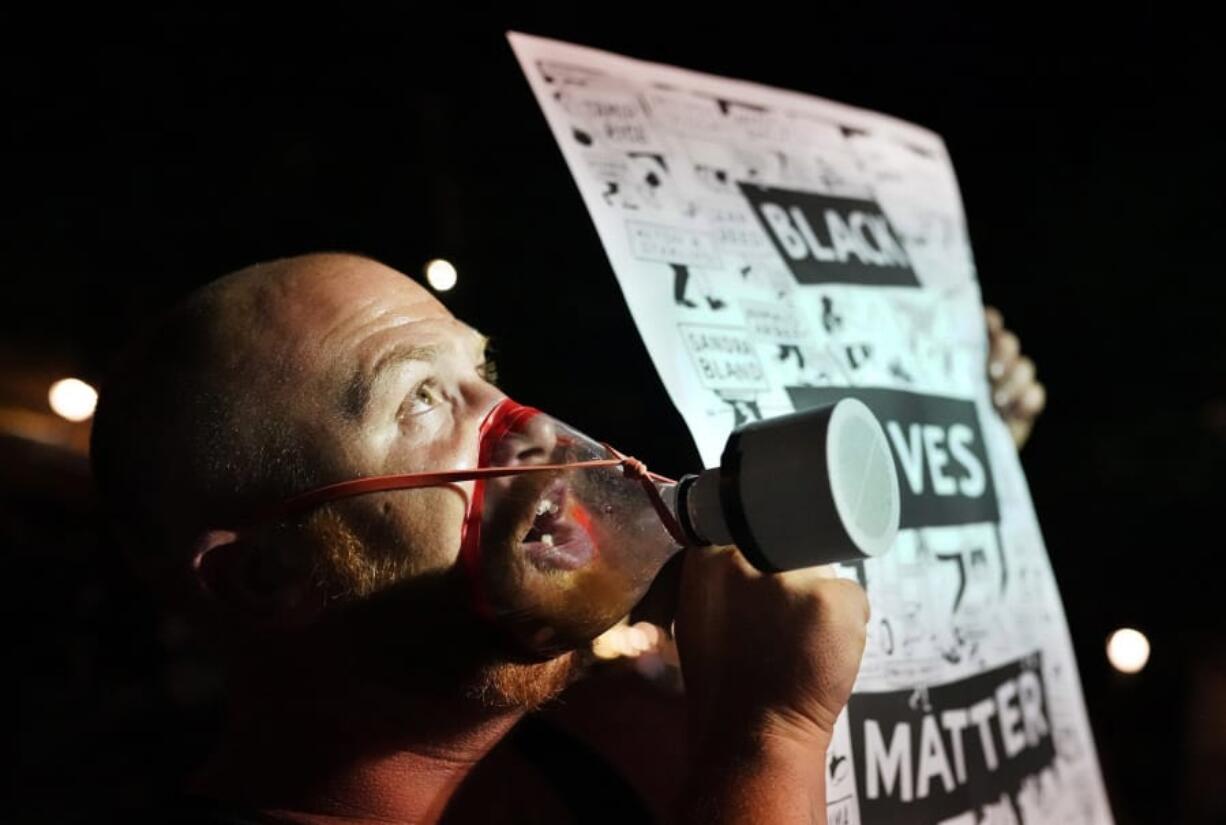 A protester with a home-made gas mask chants toward the Mark O. Hatfield U.S. Courthouse during a protest against racial injustice and police brutality on July 30, 2020 in Portland, Oregon.