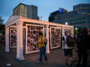 Demonstrators walk by a memorial for 216 Black lives taken by racial violence during a night of protest against racial injustice and police brutality on July 31, 2020 in Portland, Oregon.