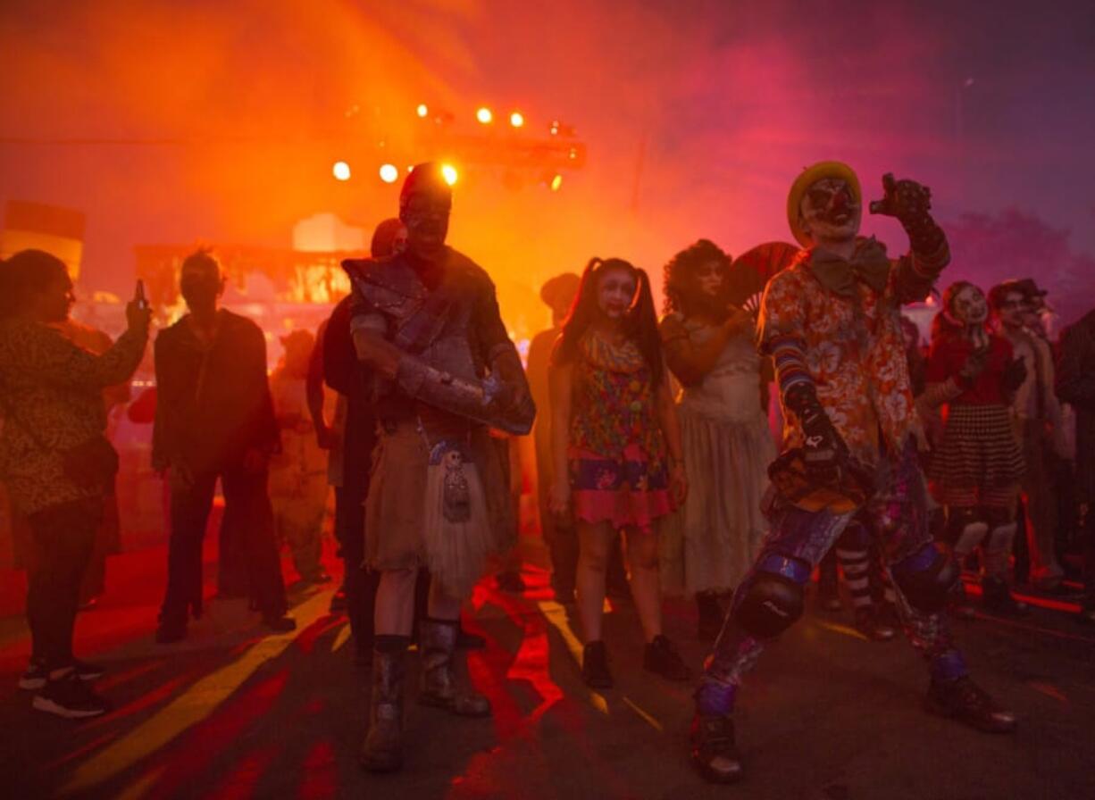 Monsters wait for the gates to open to greet guests at Queen Mary&#039;s Dark Harbor Halloween celebration.