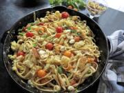 Pasta tossed with charred cherry tomatoes, basil and mozzarella makes an easy and quick dinner.