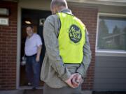 Luepke Center manager Dean Scelza chats with a client, who declined to give their name, while on delivery for Meals on Wheels People in March. Scelza was careful not to shake hands or come too close to those on his delivery route to keep both himself and his clients healthy.