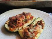 Zucchini stuffed with spicy sausage, fresh tomatoes and cheese is full of summer flavors.