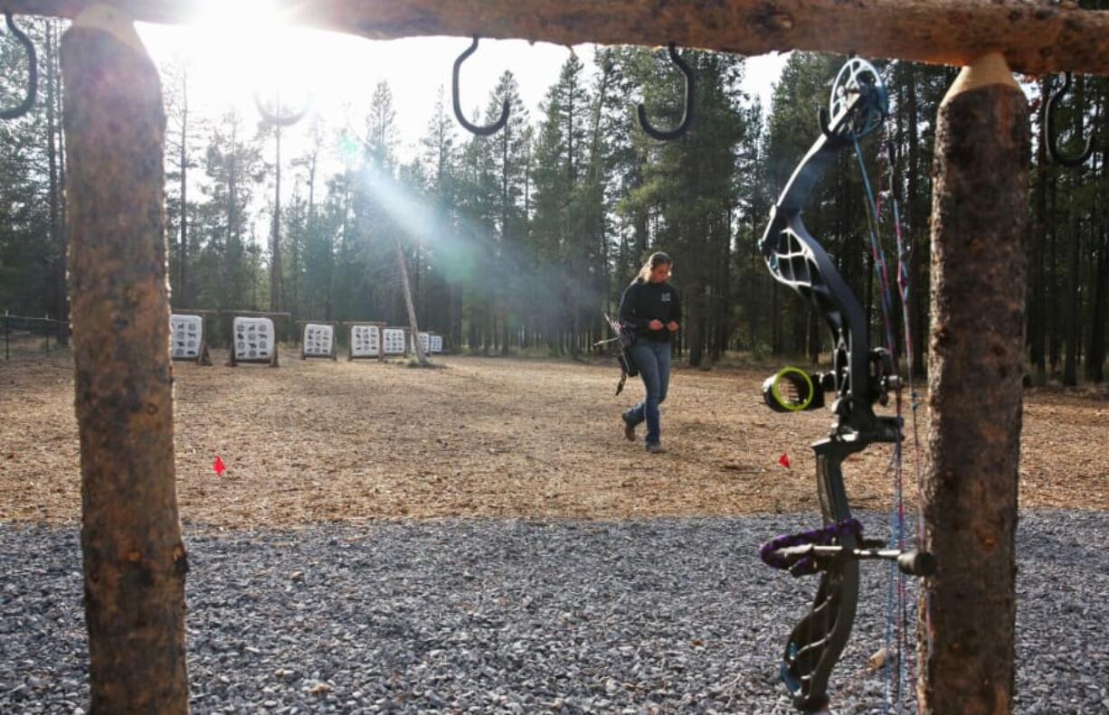 Caitlin Lohner, 14, of LaPine retrieves her arrows while practicing at the new archery range in Kelly Young Memorial Park in LaPine, Ore.