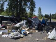 Officer Tyler Chavers stops to check on residents of a homeless encampment in northeast Vancouver in July.