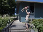 Van Lattin of Vancouver, who was born last August, gets a lift from his mom, Cindy Lowry, while enjoying some playtime near the Marshall Center in Vancouver.