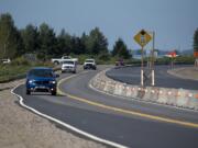 Motorists traveling east on state Highway 14 in Washougal pass an elevated section of the road as construction crews work near Steigerwald Lake National Wildlife Refuge. The highway is being raised above the 500-year flood level in preparation for the removal of a section of levee to restore the Steigerwald area&#039;s connection to the Columbia River.