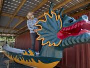 Patricia Thompson, president of the Ridgefield Art Association, looks over one of the restored dragon boats Thursday afternoon at the Port of Ridgefield. Roughly 5 feet, 4 inches wide, the boats can hold 22 people.