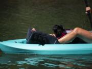 Roo joins her owner Kelly Kopp as they kayak along an offshoot of the Columbia River in Vancouver on August 15, 2020.