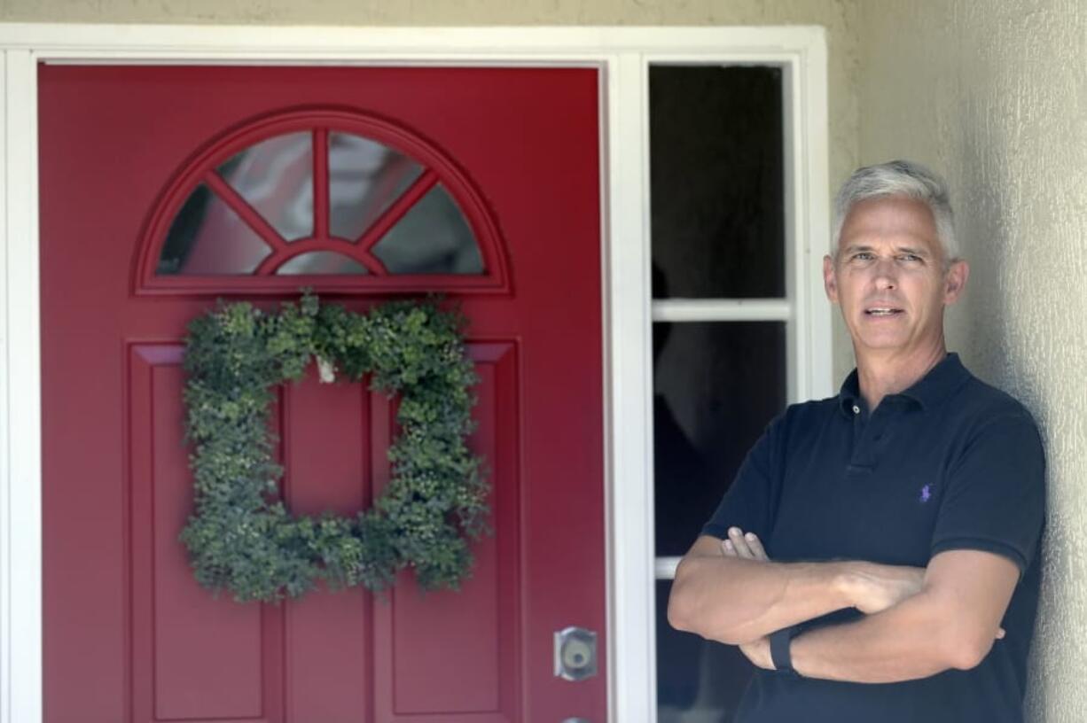 Bob Garick stands by the entrance to his home Wednesday, Aug. 5, 2020, in Oviedo, Fla. Garick was looking forward to being a field supervisor during the door-knocking phase of the 2020 census, but as the number of new coronavirus cases in Florida shot up last month, he changed his mind and decided not to take the job.