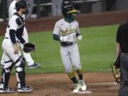 Oakland Athletics' Tony Kemp (5) scores in front of Seattle Mariners catcher Joe Hudson in the 10th inning of a baseball game Saturday, Aug. 1, 2020, in Seattle. The Athletics won 3-2.