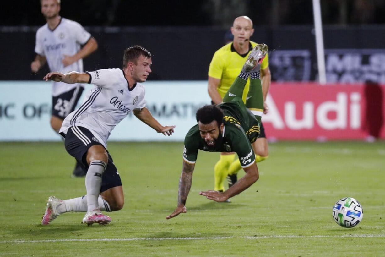 Philadelphia Union defender Kai Wagner, left, and Portland Timbers midfielder Eryk Williamson collide during the first half of an MLS soccer match, Wednesday, Aug. 5, 2020, in Kissimmee, Fla.