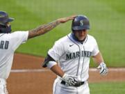 Seattle Mariners' Kyle Seager, right, is congratulated by J.P. Crawford on his three-run home run against the Los Angeles Angels in the third inning of a baseball game Wednesday, Aug. 5, 2020, in Seattle.