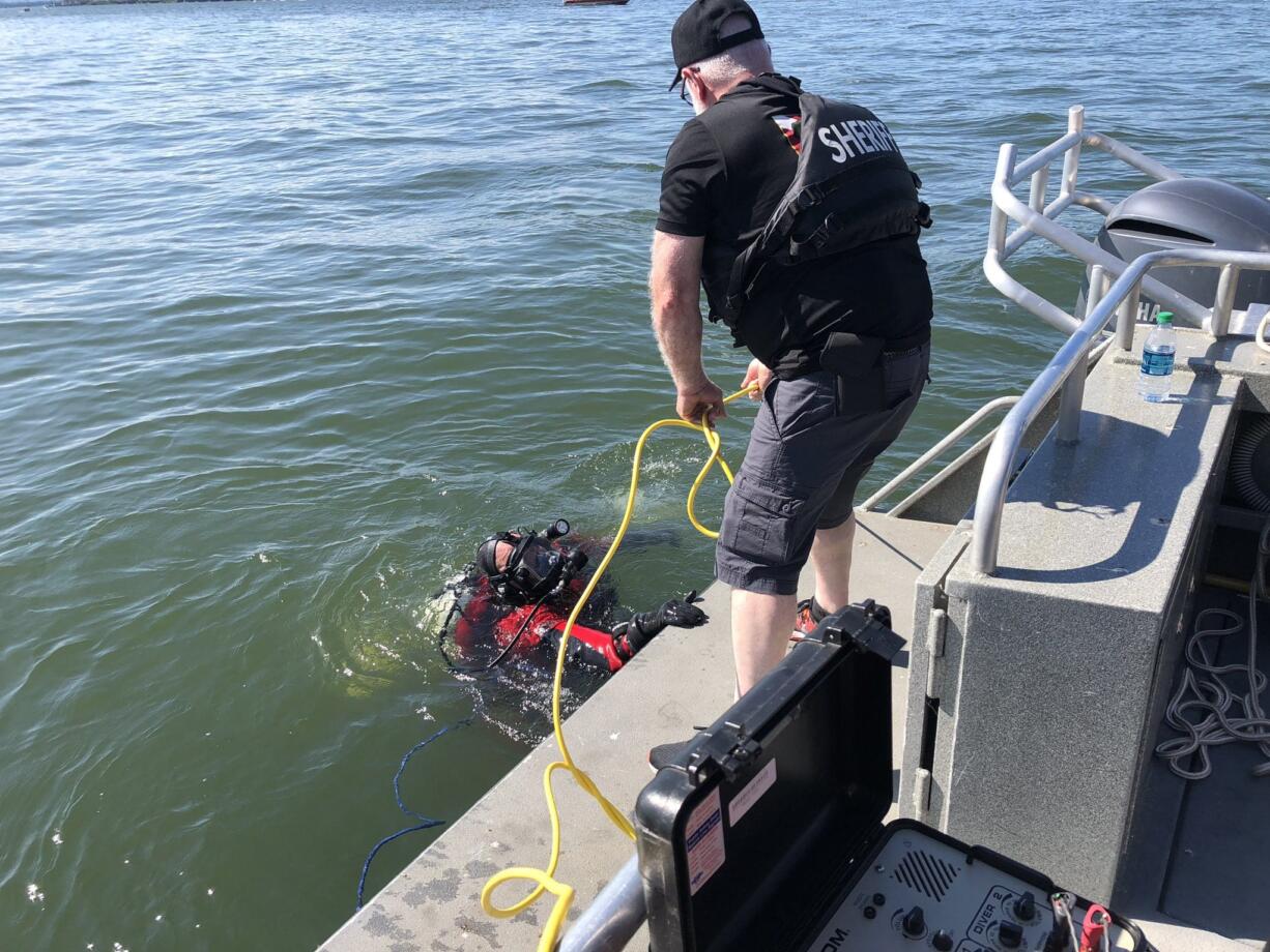 A dive team from the Multnomah County Sheriff's Office searches the Columbia River off Marine Drive for a man presumed drowned on Sunday, Aug. 2. The man, who was not wearing a life jacket, was ejected from a speeding boat that flipped just before 2 p.m. on Sunday.