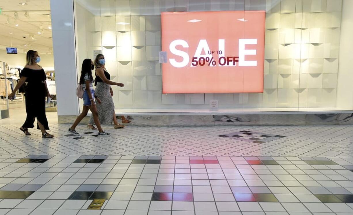 FILE - In this Aug. 11, 2020 file photo, shoppers walk through the Valley Mall in Halfway, Md.  U.S. consumer confidence fell for second straight month in August as a resurgence of virus cases in many parts of the country heightened pessimism about the economy.