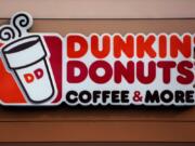 FILE - This Jan. 22, 2018, file photo shows a Dunkin&#039; Donuts logo on a shop in Mount Lebanon, Pa. The Massachusetts-based coffee and donuts empire is teaming with Post Consumer Brands to release two new breakfast cereals based on two of its most popular coffee drinks: Caramel Macchiato and Mocha Latte. The new cereals are expected to hit grocery shelves in late August 2020. (AP Photo/Gene J.